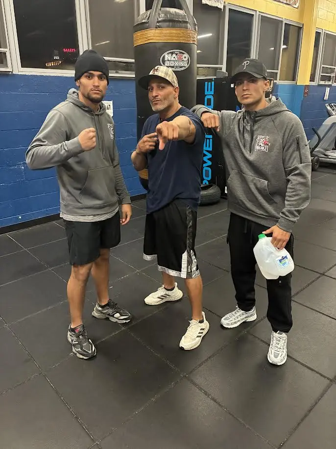 Christian Figueroa with his brother Justin and their father in a boxing gym