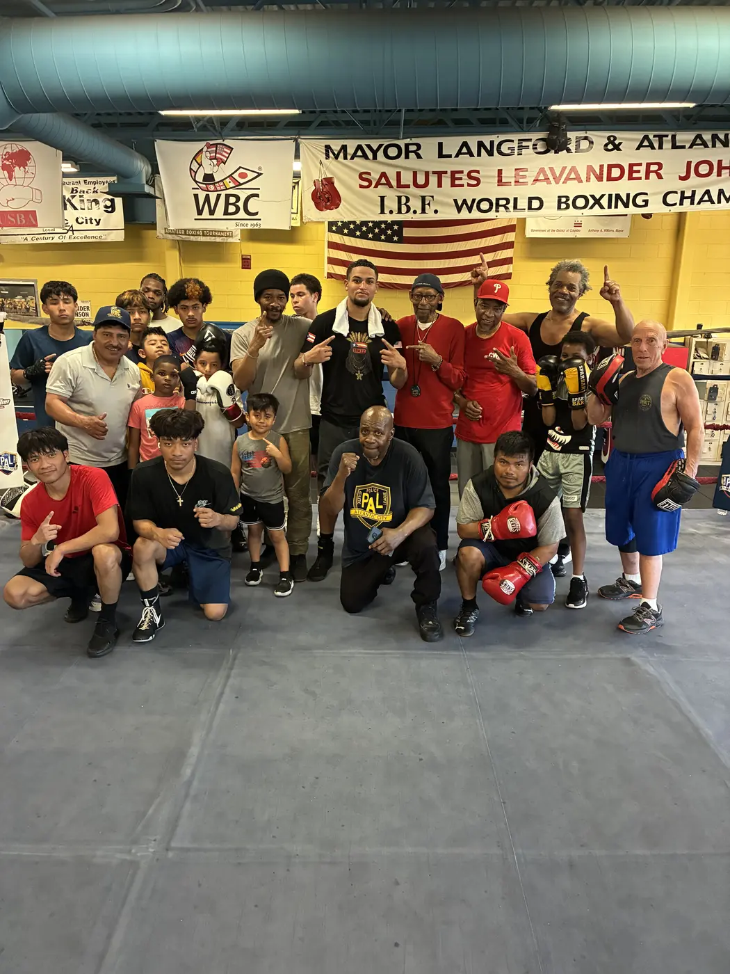 Young athletes and mentors gathered inside a boxing gym